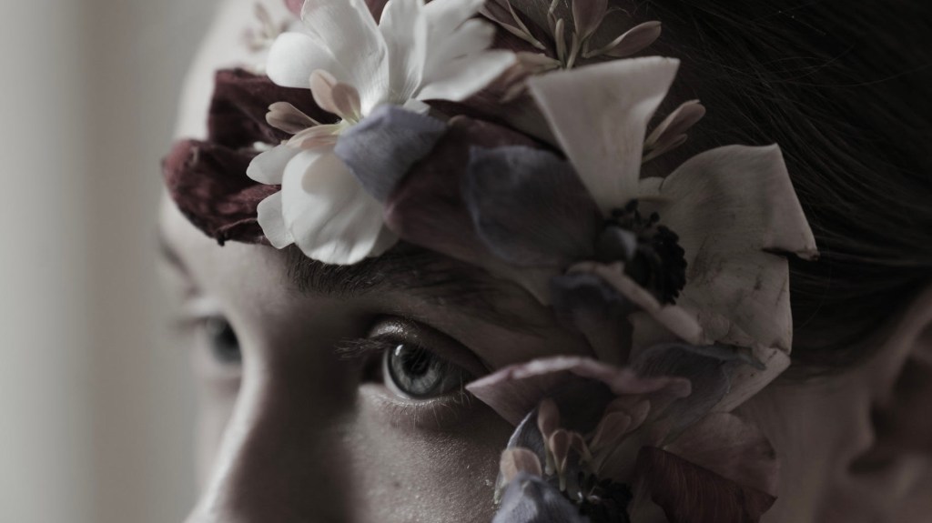 woman with flowers around her face
