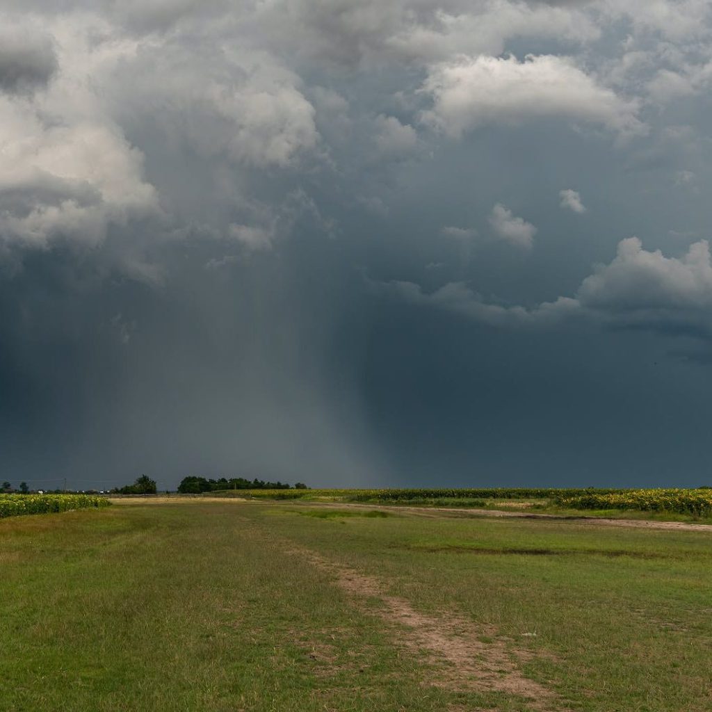 agricultural farmland landscape under dark clouds