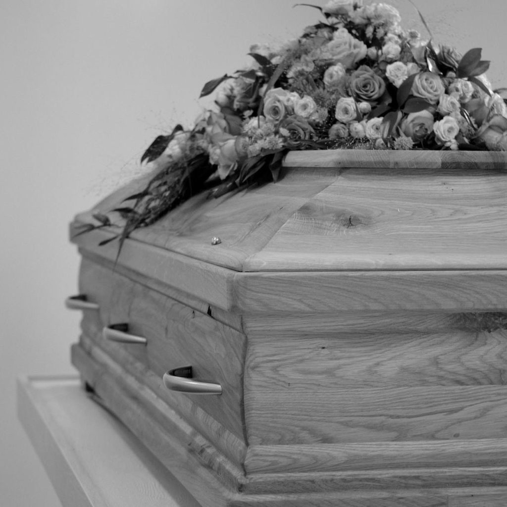 grayscale photo of a coffin